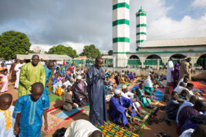 Gambian Muslims, both young and old, fill the local mosque in Sinchu and every available space outside to pray during the first day of Tabaski.Eid al-Adha, or known as Tabaski in West Africa, is also called the Feast of Sacrifice. Celebrated throughout the Muslim world is the second of the two Eid celebrations. During Tabaski every family will buy a goat which will be sacrificed and the meat distributed between the family and friends.